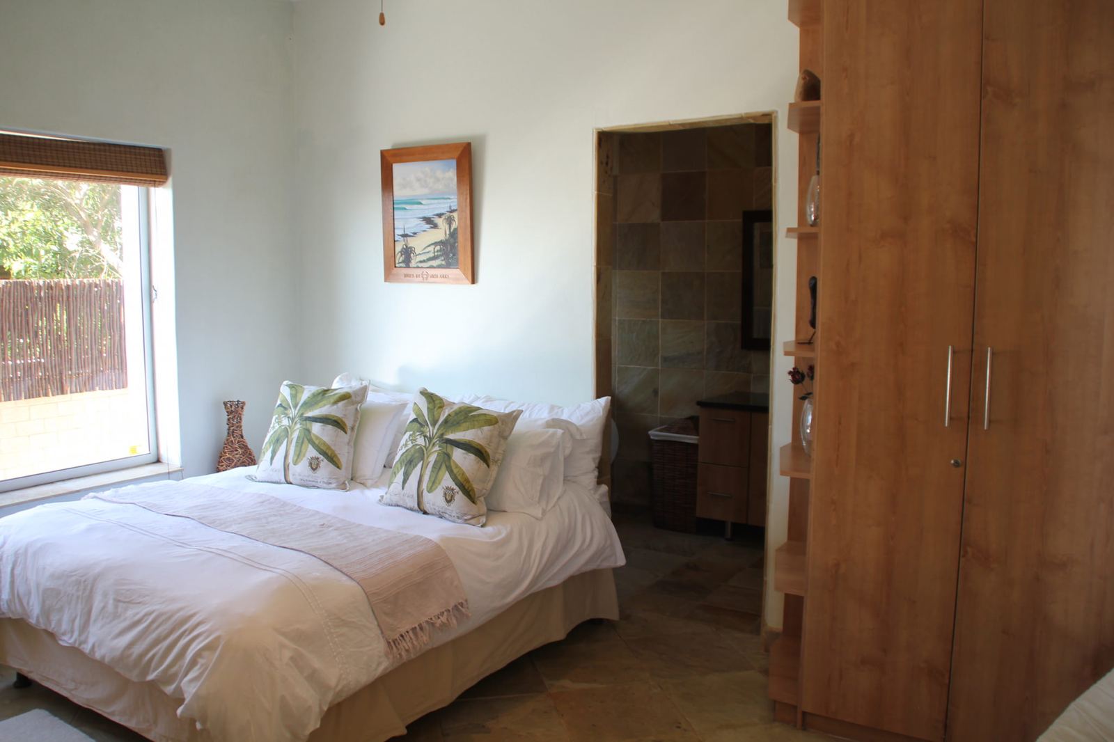 Tubes en-suite bedroom with white linen